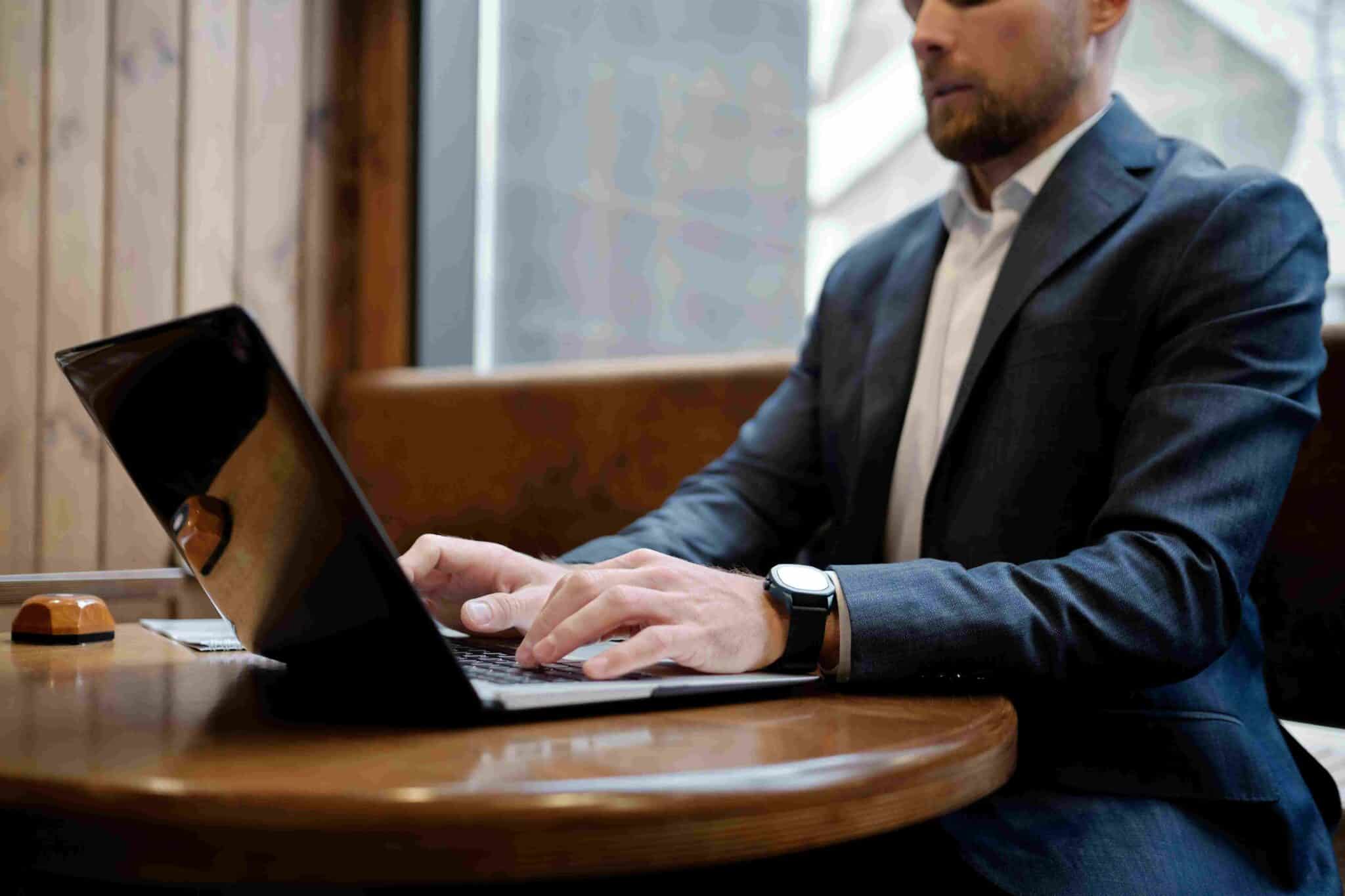 part time cfo typing on laptop at desk
